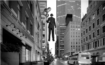 This is a photo of a man floating in the city.