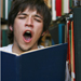 Photo of yawning boy with book