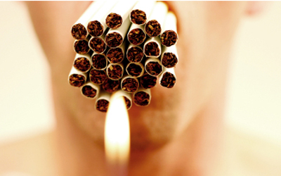 This is a photo of a man smoking many cigarettes