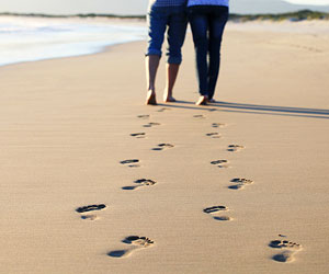 This is a photo of a couple's footsteps on a beach.