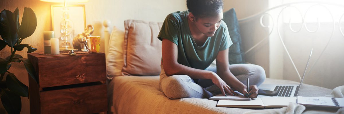Full length shot of a young female student studying at home