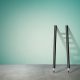 Two pencils propped on wall with ladder shadow