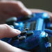 This is a close up photo of a videogame controller being used.