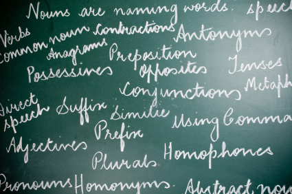 Image of English Grammar text handwritten on greenboard. 