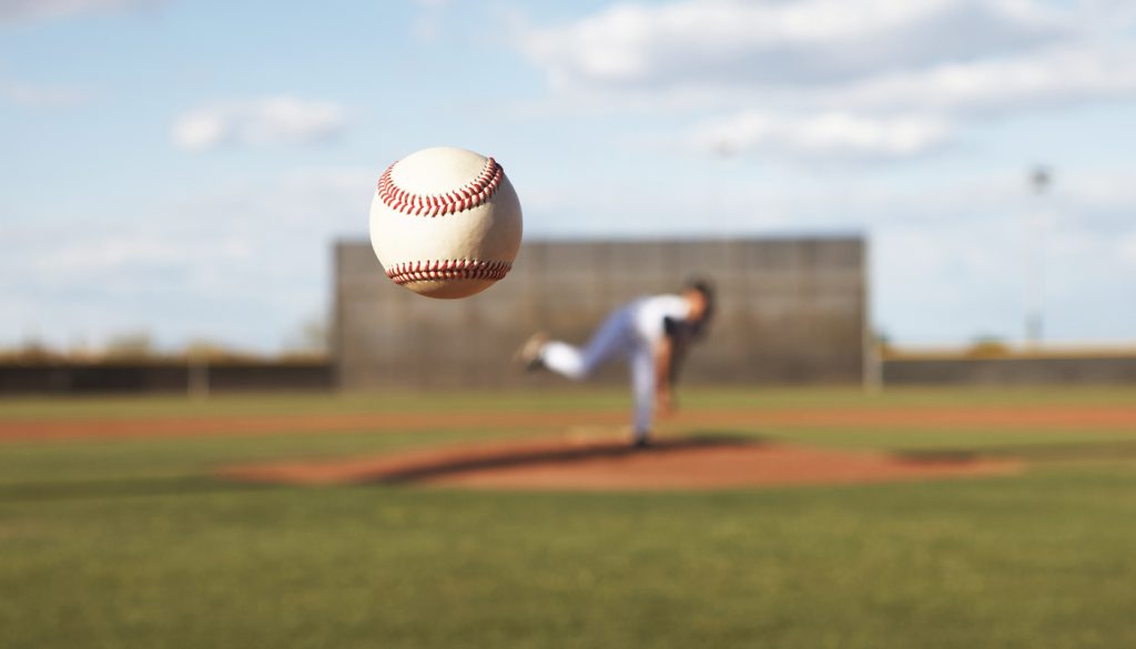 Pitcher tosses ball to home plate