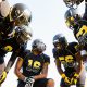 Football team huddled during time out while playing game