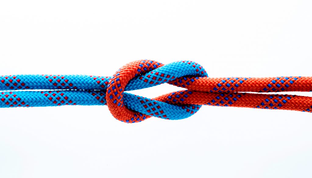 Rope with reef knot isolated on white background.