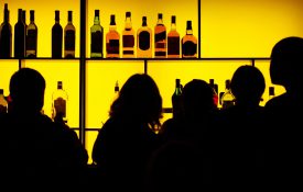 Silhouettes of people at a cocktail bar
