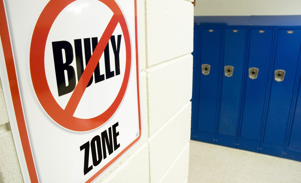 No bullying sign posted in a school hallway.