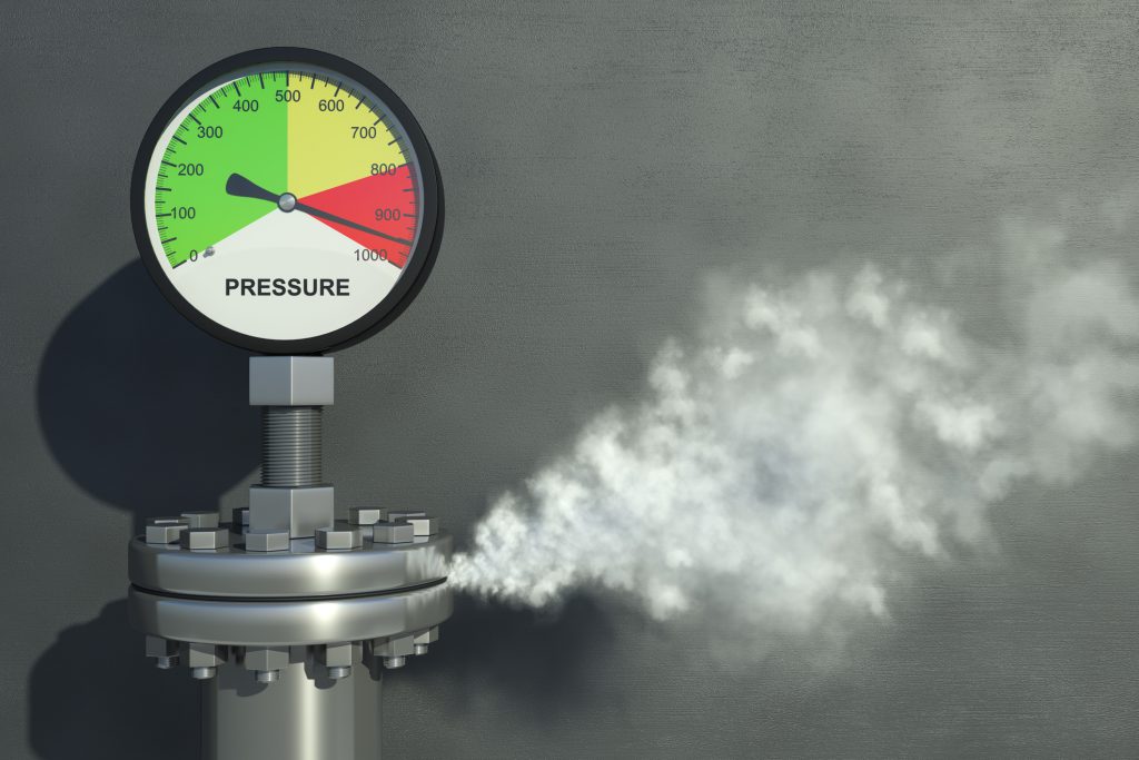 Gas or steam leaking from an industrial pressure gauge