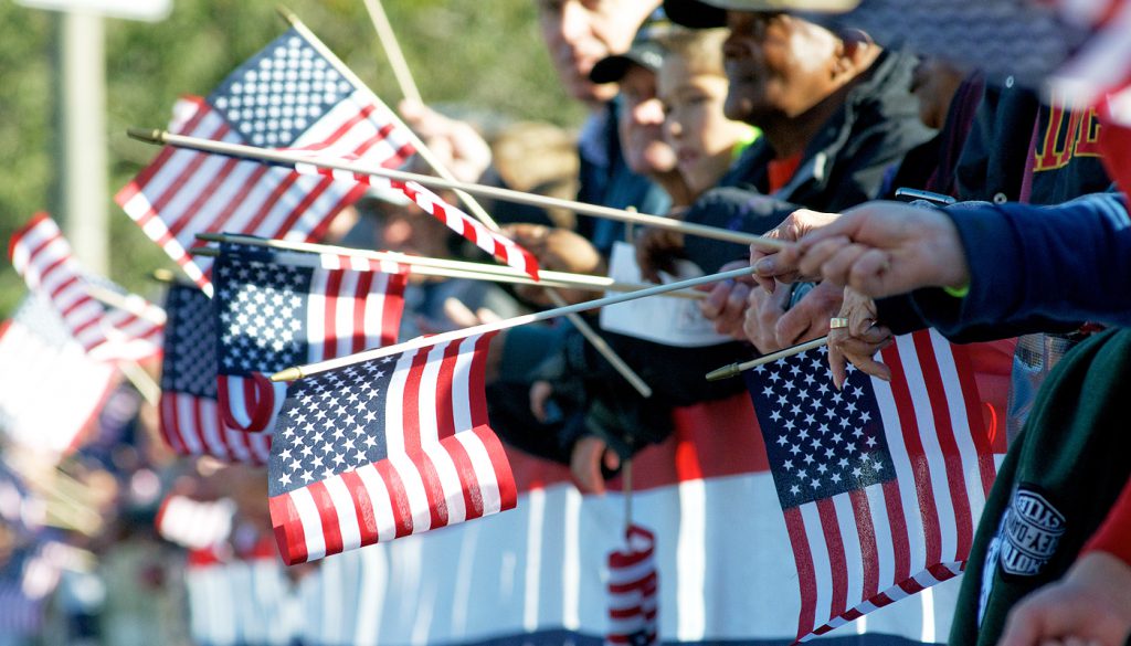 People holding American flags at the Philadelphia Veterans Day parade