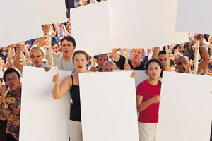 This is a photo of people holding blank signs at a protest.