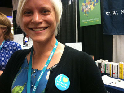 This is a photo of a woman searign an "I love Research Methods" pin.