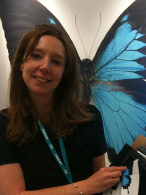 This is a photo of a woman holding butterfly-imprinted screen cleaner.