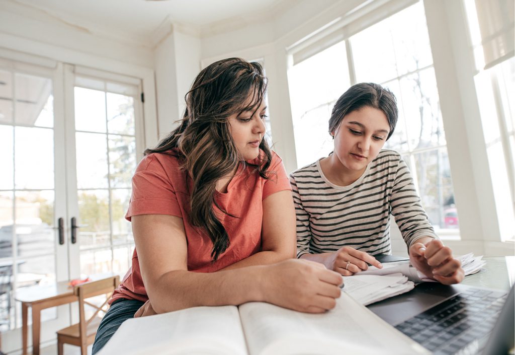 Mother reviewing school assignment with her daughter