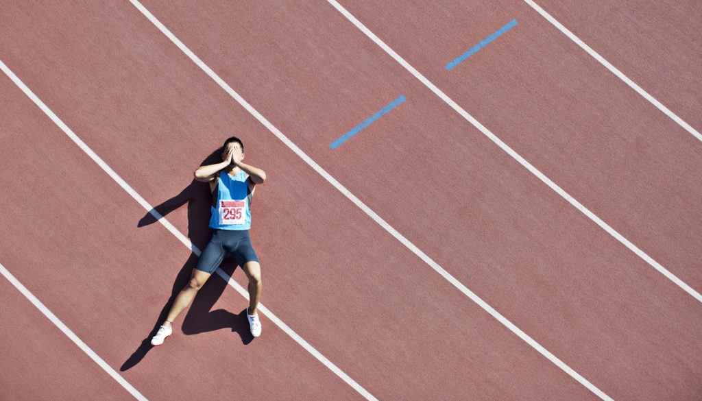 Tired runner laying on track