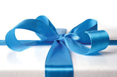 This is a photo of a present with a bow. Read the latest psychological science on giving to others, giving yourself more time, and regifting too!
