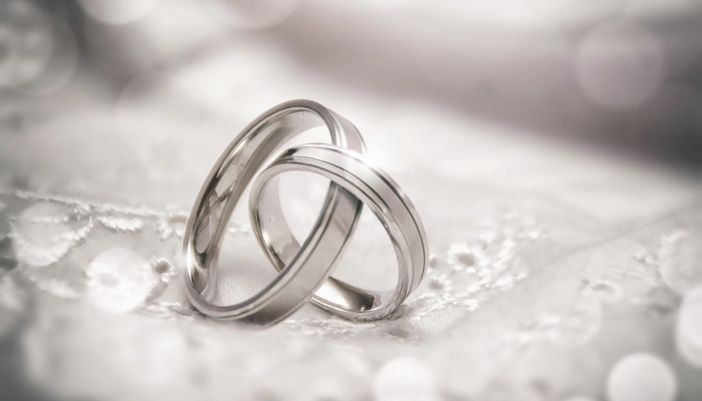 Two silver wedding rings linked together