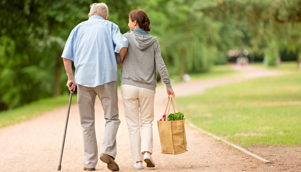 This is a photo of a caregiver helping senior man with shopping.