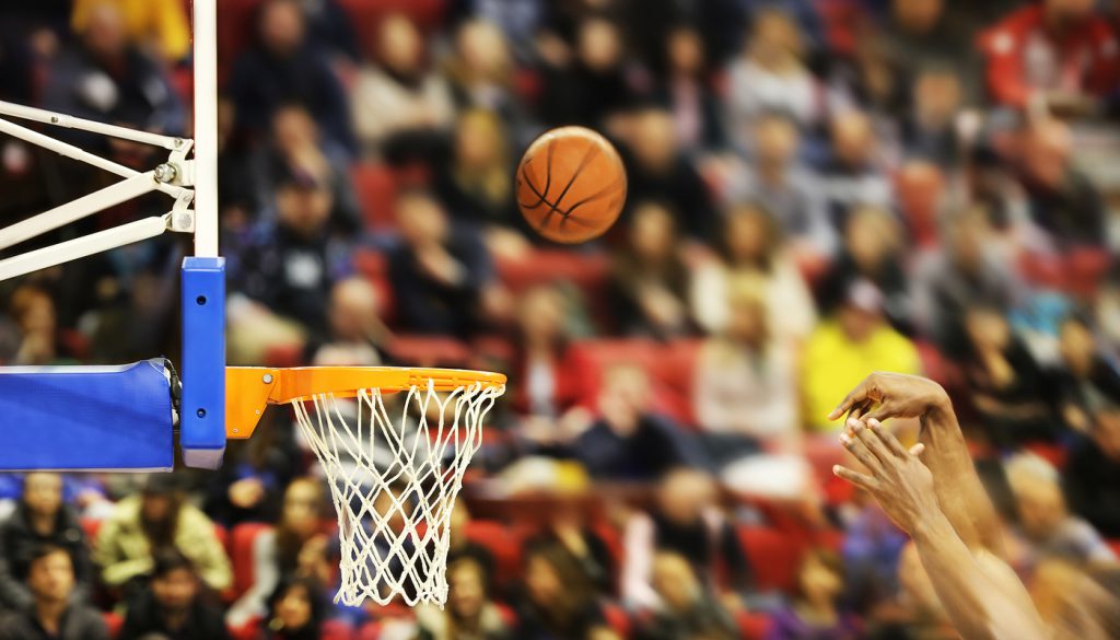 Scoring the winning points at a basketball game , motion blur