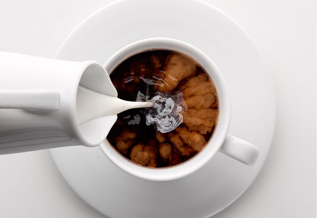 This is a photo of milk being poured into coffee