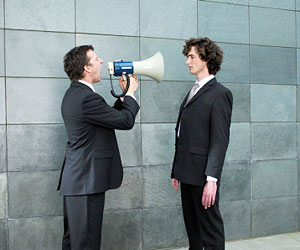 This is a man yelling through a megaphone at another man.