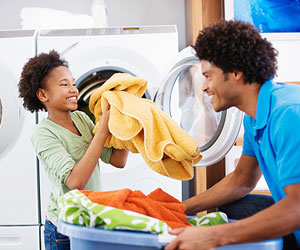 This is a photo of a father and daughter doing laundry.
