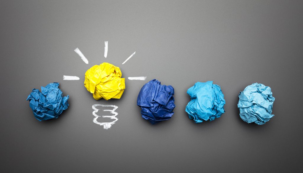 Light bulb crumpled paper on a blackboard