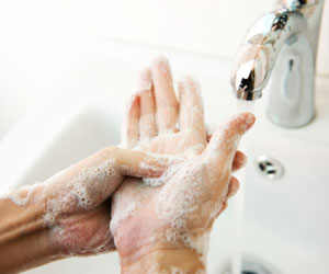 This is a photo of a person washing their hands with soap.