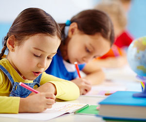 This is a photo of two preschool girls taking a test.