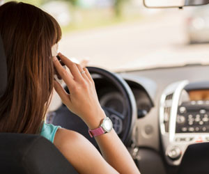 This is a photo of a woman talking on the phone while driving.
