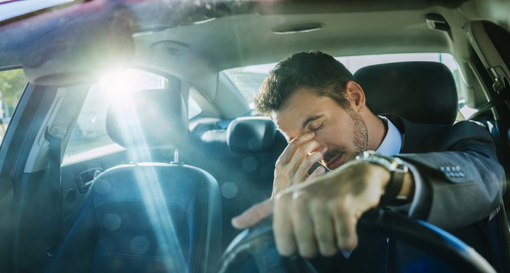 Exhausted businessman stuck in traffic