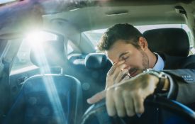 Exhausted businessman stuck in traffic