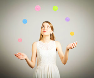 This is a photo of a woman juggling several balls.