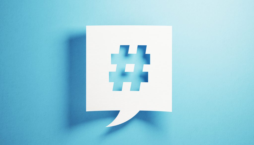 White chat bubble containing a hashtag, against a blue background.