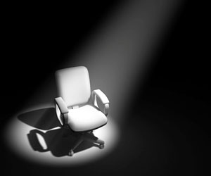 This is a photo of a chair under a spotlight.
