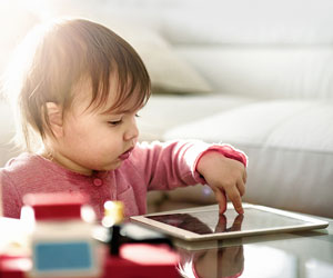 This is a photo of a toddler using a tablet.