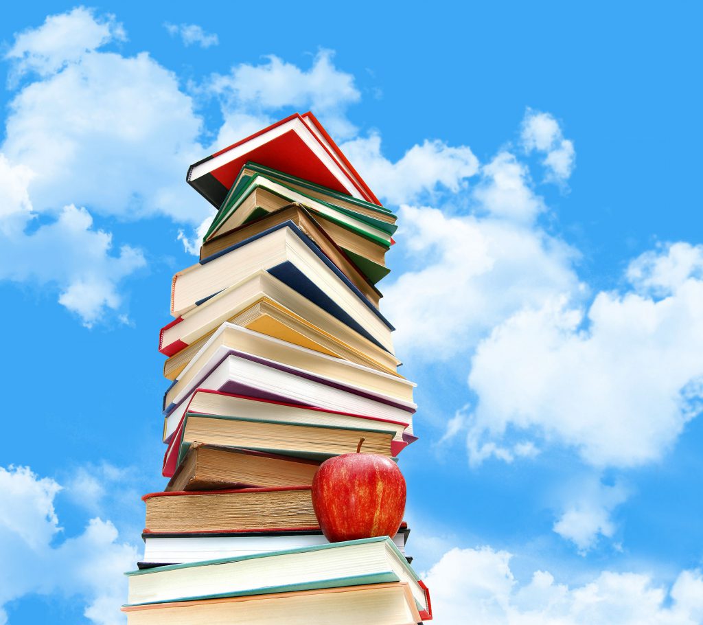 This is a photo of a stack of books against a blue sky.