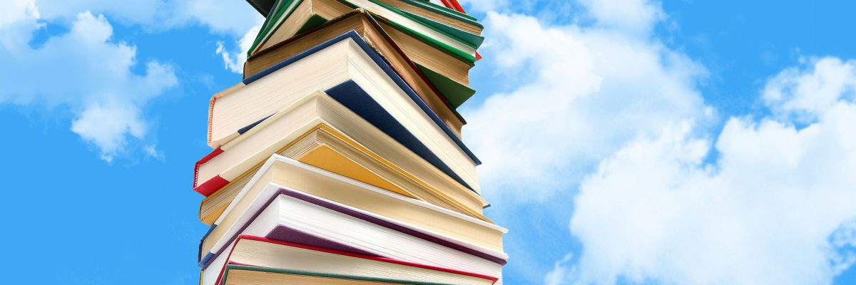 This is a photo of a stack of books against a blue sky.