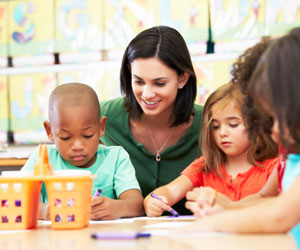 This is a photo of children coloring in daycare.