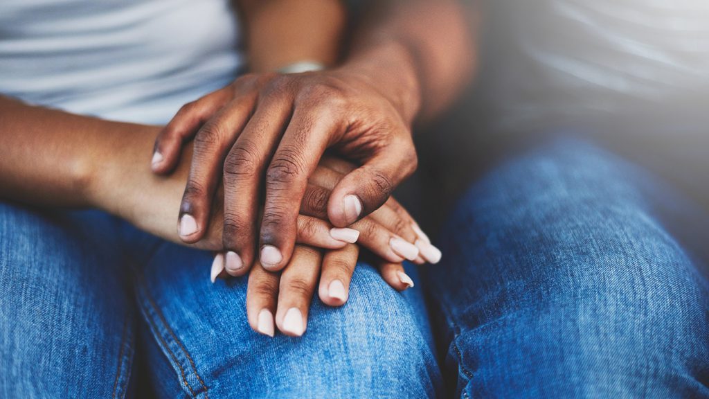 Closeup shot of an unrecognizable couple holding hands in comfort