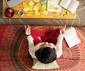 This is a photo of a woman meditating while studying.