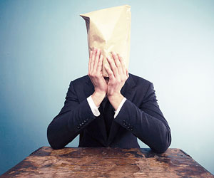 This is a photo of a businessman with a bag over his head.