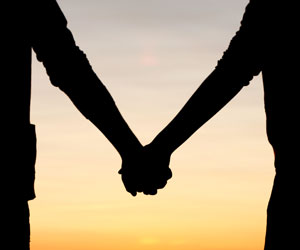 This is a photo of a couple holding hands.