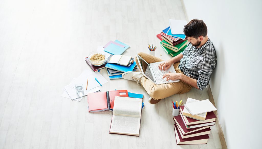 Student using different sources of information to prepare for exam