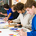 This is a photo of students painting in an art classroom.