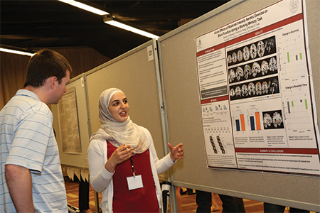 Seima I. Al-Momani presents her poster on the effects of aerobic exercise on brain function during a task that measures working memory. More than 2,700 posters were accepted for the convention.