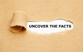 This is a photo of paper torn back to reveal the phrase "uncover the facts"