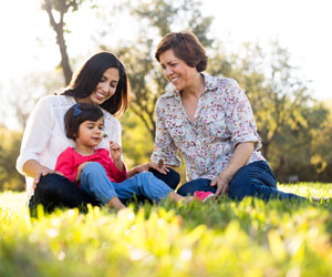 This is a photo of three generations of women in the park.