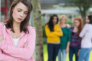 This is a photo of a girl being ostracized by a group of people.